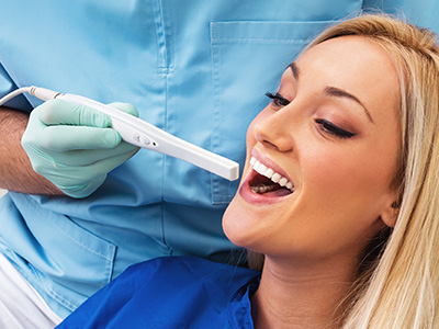 An image featuring a dental professional assisting a patient with a dental device, likely during a dental procedure.