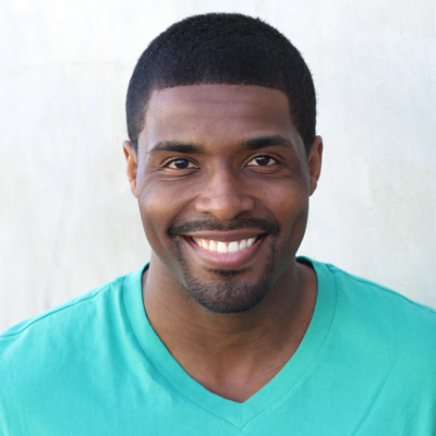 An elderly couple sharing a joyful moment, with the man smiling and holding his arm around the woman s shoulder.